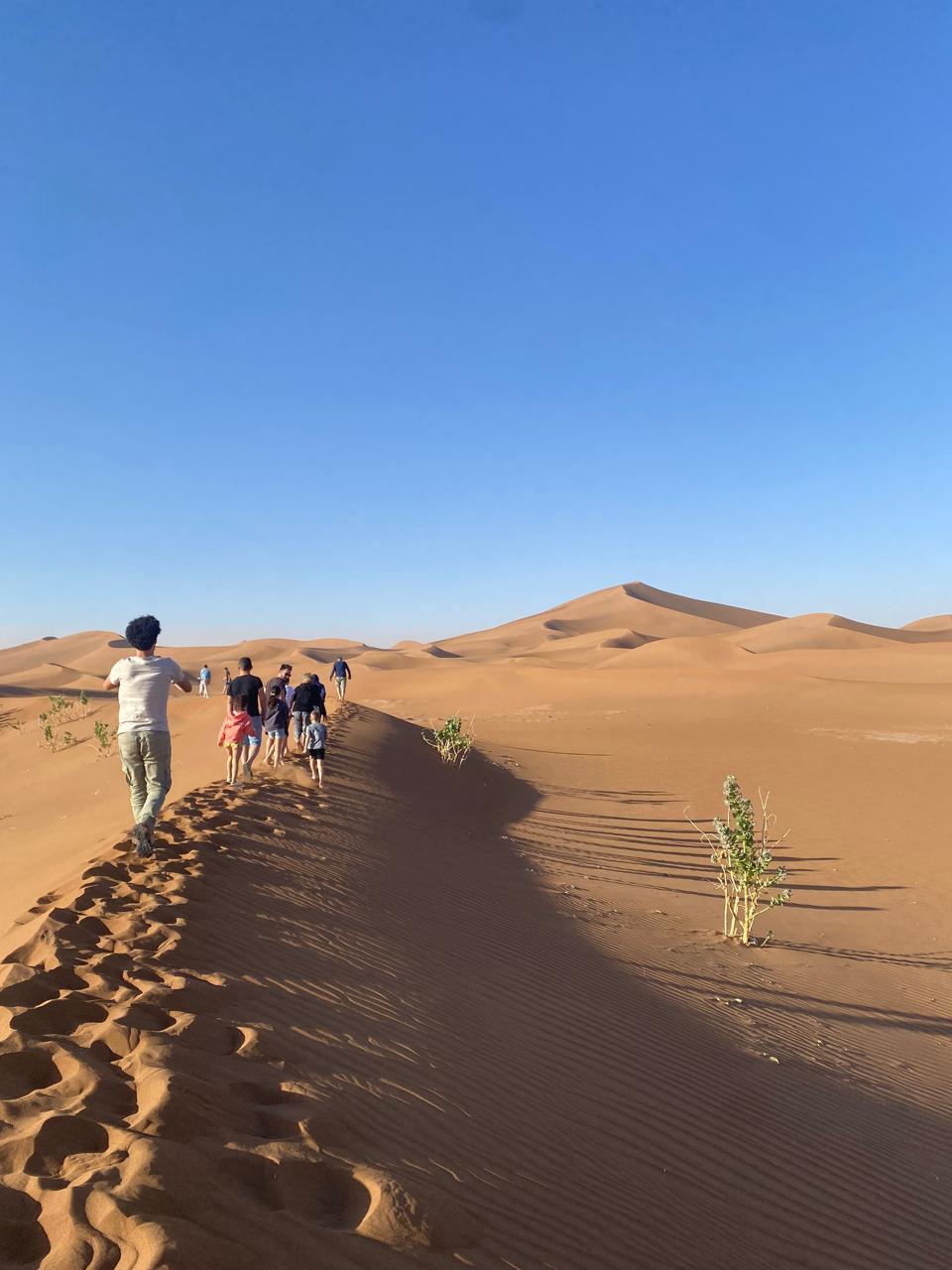 Walking the dune ridgeline at golden hour